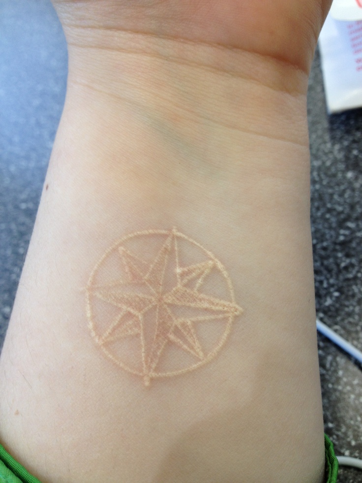  white compass tattoo